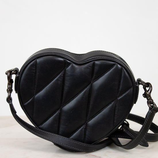 Black heart-shaped bag on a light background