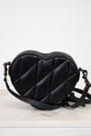 Black heart-shaped bag on a light background