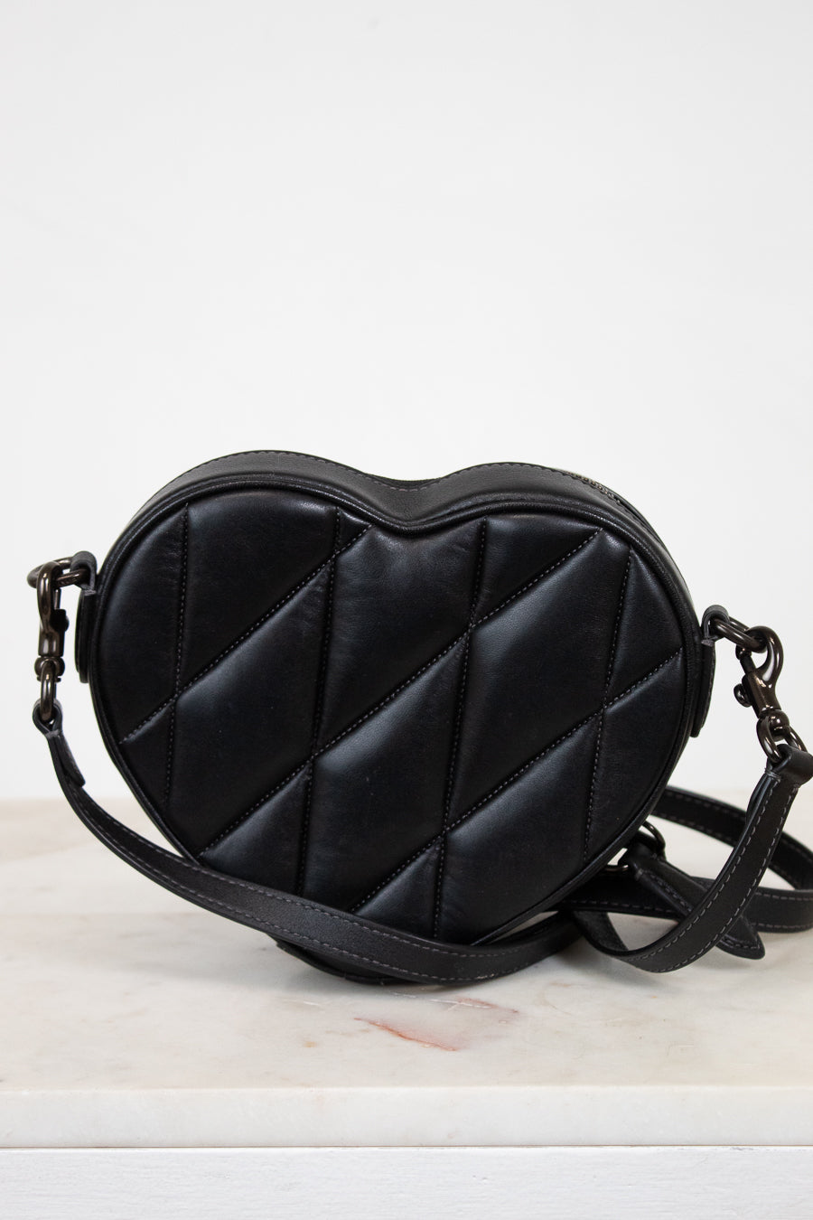 Black heart-shaped bag on a light background