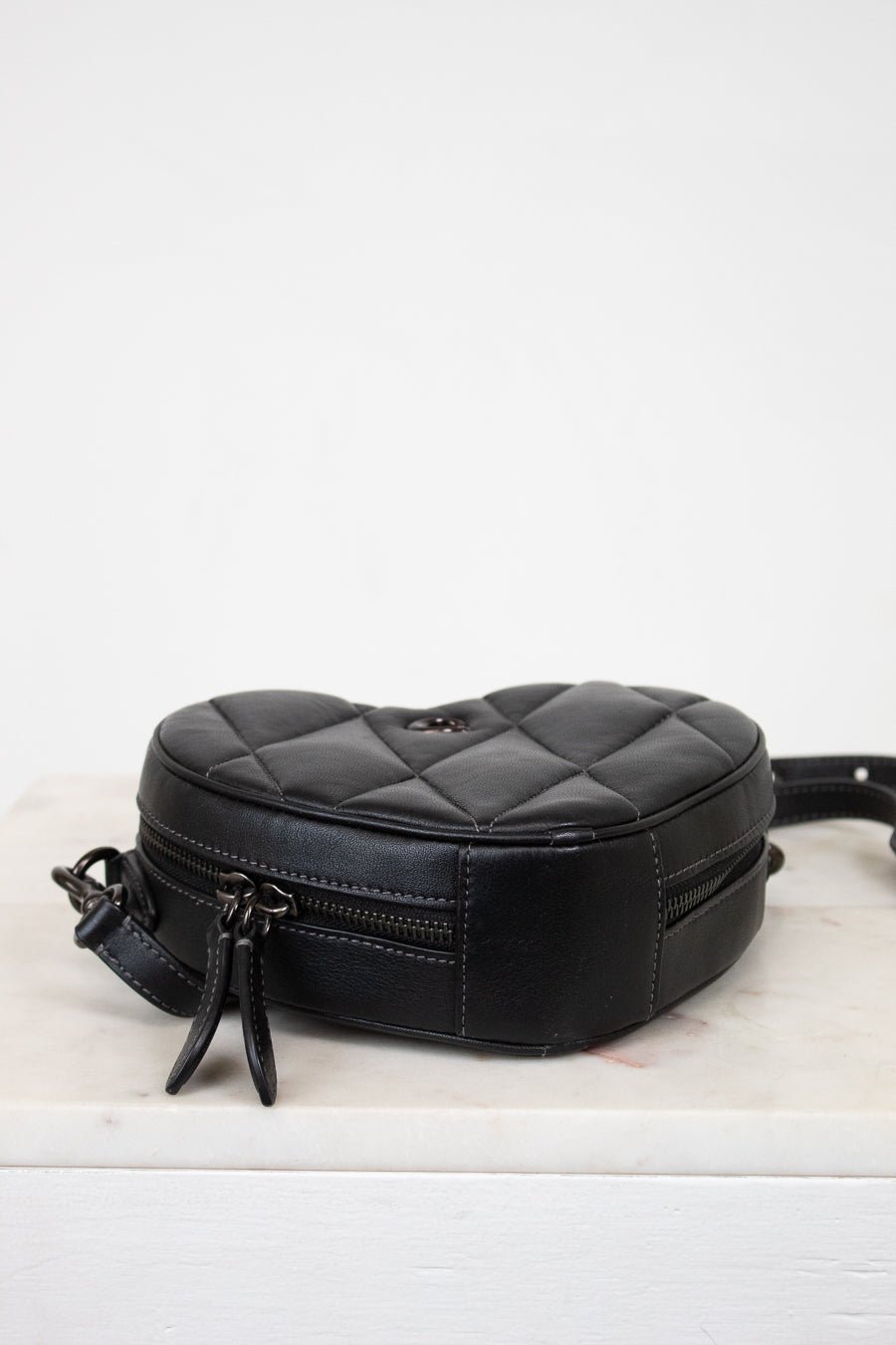 Black quilted bag on a white background