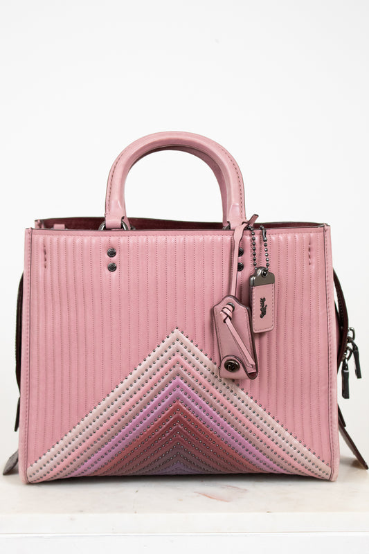 Pink handbag with a chevron pattern on a white background