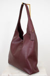 Maroon leather handbag on a white background