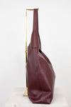 Maroon leather handbag on a white background