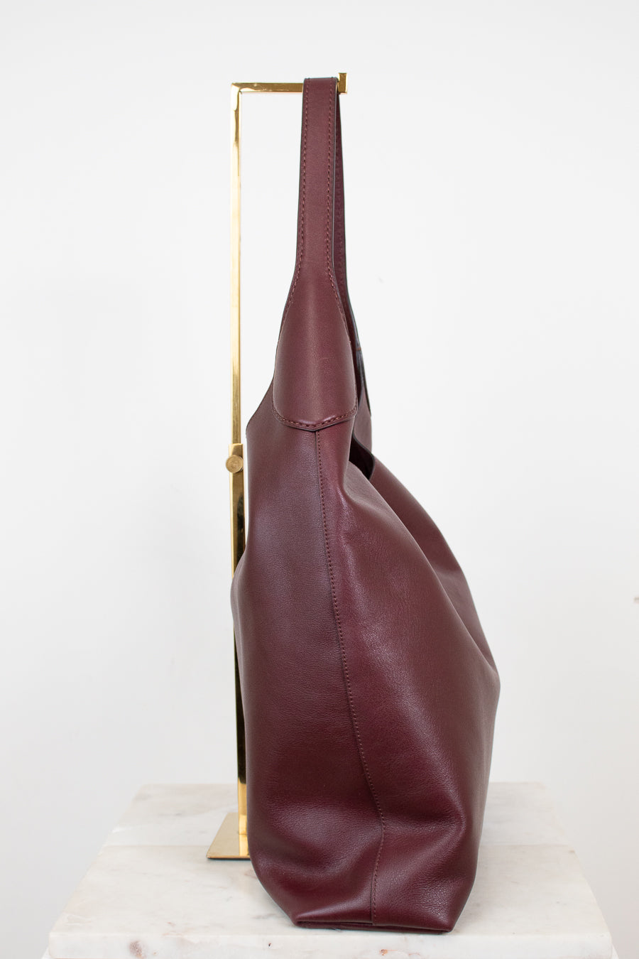 Maroon leather handbag on a white background