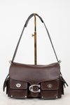 A dark brown leather shoulder bag with silver-tone hardware, displayed on a gold-colored stand against a white background.