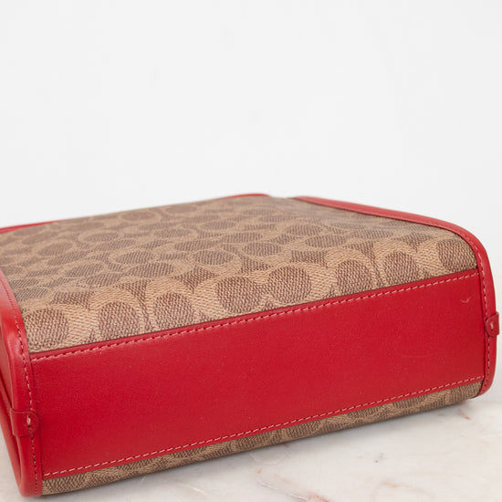 Red base of purse with brown patterned top section on a white surface