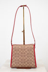 Patterned handbag with a red strap on a white background