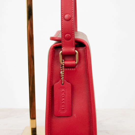 Red handbag with gold accents on a white background