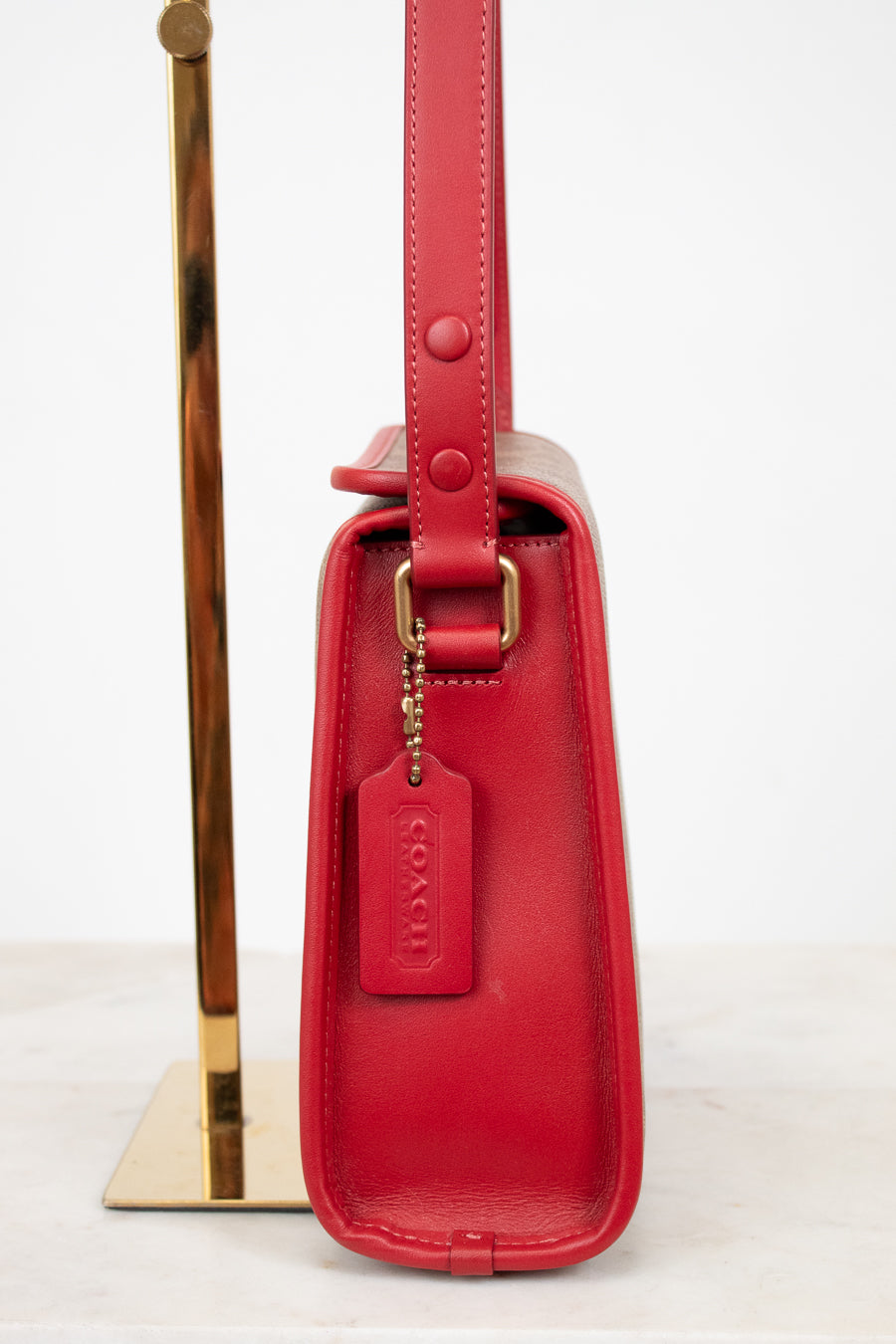 Red handbag with gold accents on a white background