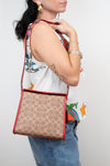 Person holding a patterned handbag with a plain background