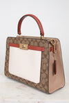 Designer handbag with brown and red accents on a light background