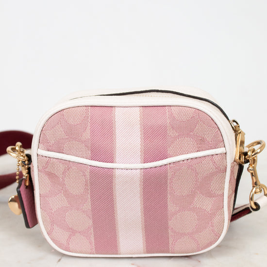 Pink and white striped handbag on a light background