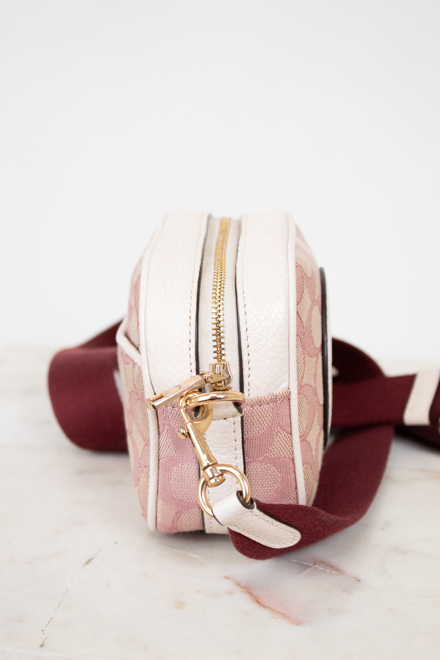 Small bag with a gold zipper and clasp on a marble surface