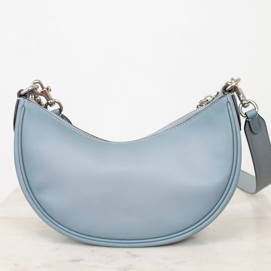 Back of light blue handbag.