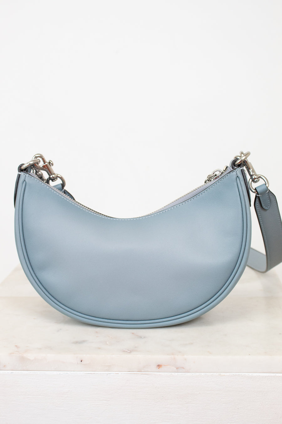 Back of light blue handbag.