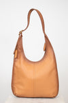 Tan leather handbag on a white background