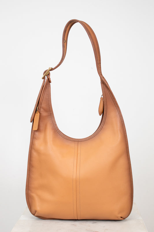 Tan leather handbag on a white background