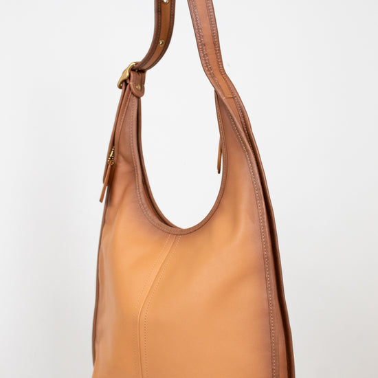 Tan leather handbag on a white background