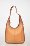 Tan leather handbag on a white background