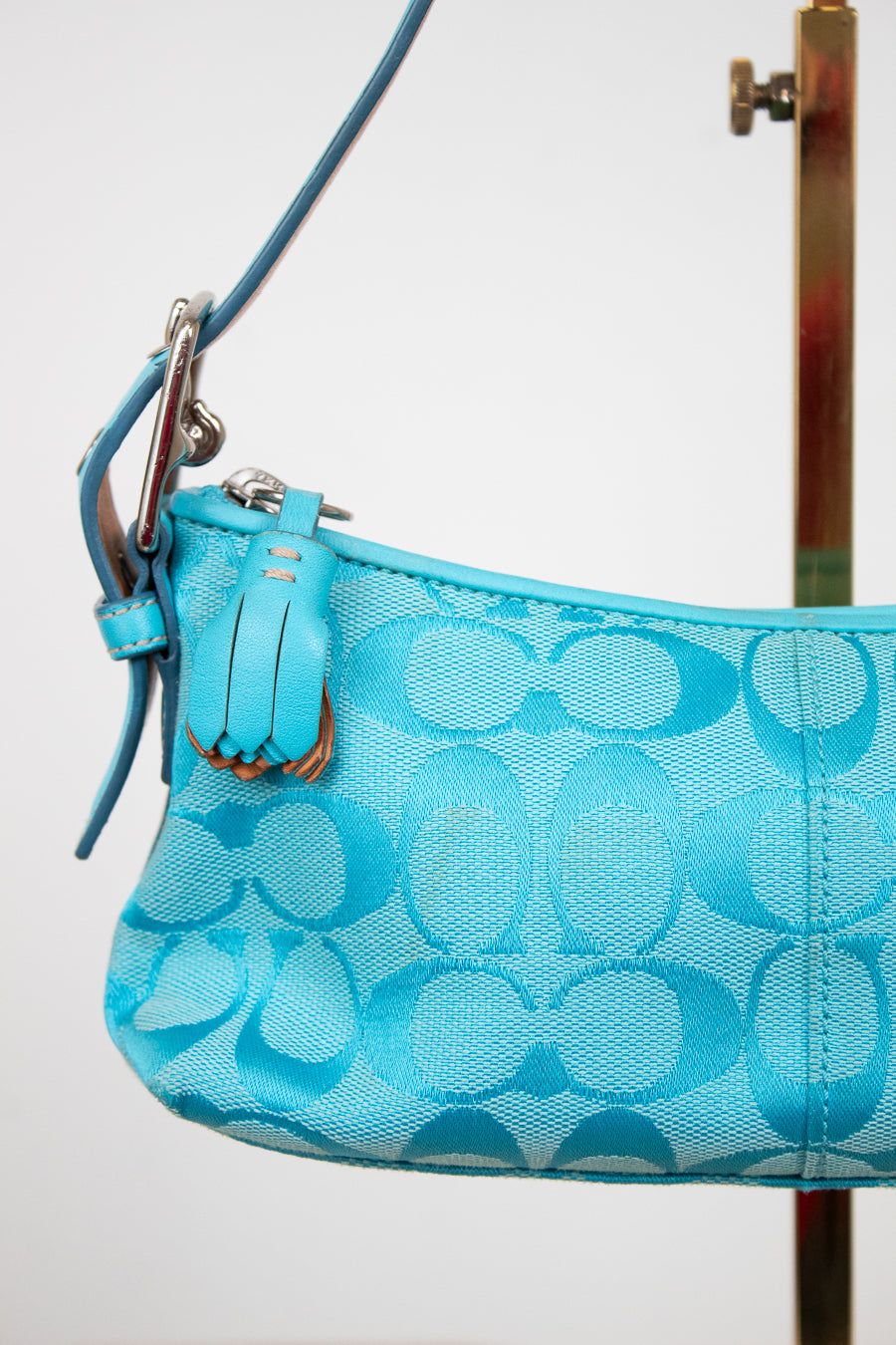 Blue patterned handbag with a strap on a white background