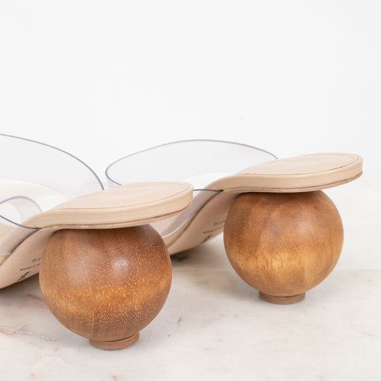 Shoe with wooden spherical heel on a light background