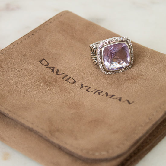 David Yurman ring with purple stone on a brown velvet dustbag