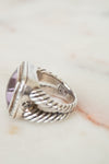 Side view of silver ring on marble background