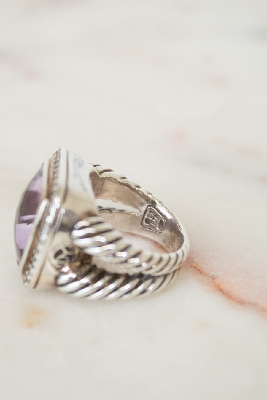 Side view of silver ring on marble background
