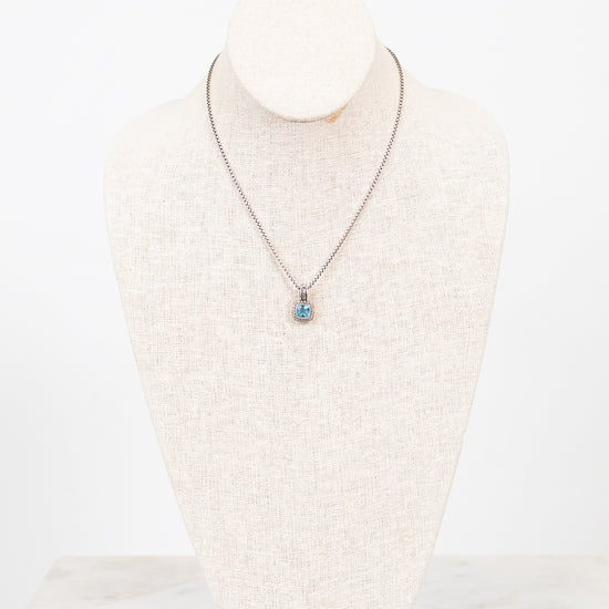 Necklace with a pendant on a mannequin bust against a white background