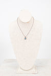 Necklace with a pendant on a mannequin bust against a white background