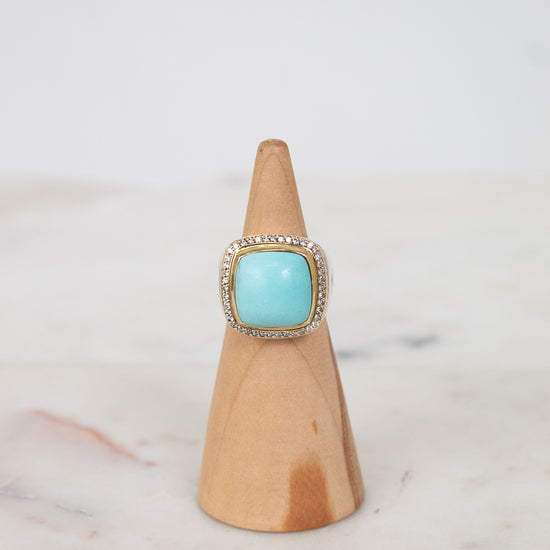 Turquoise squared center stone with gold and diamond border details