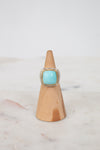 Turquoise squared center stone with gold and diamond border details