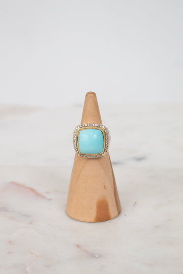 Turquoise squared center stone with gold and diamond border details