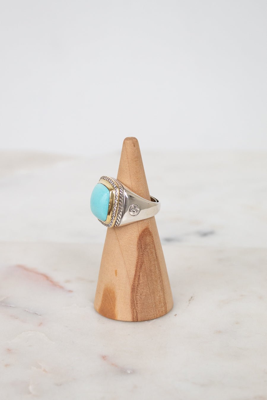 Turquoise squared center stone with gold and diamond border with side stamp detail