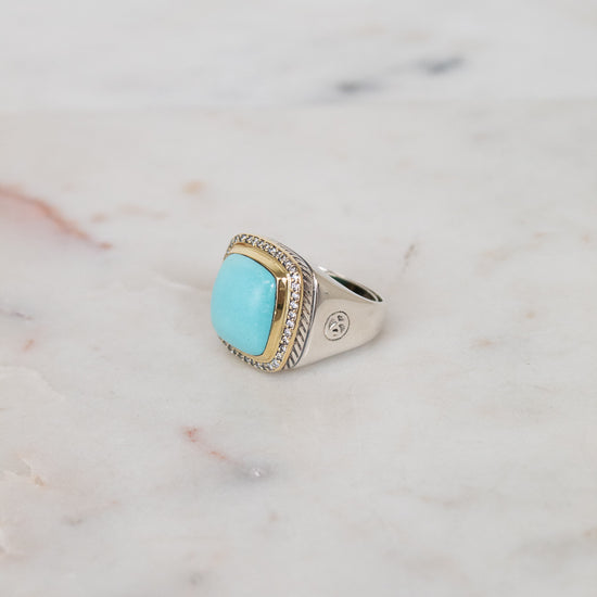 Turquoise squared center stone with gold and diamond border details and side stamping in hardware