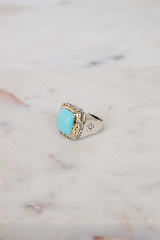 Turquoise squared center stone with gold and diamond border details and side stamping in hardware