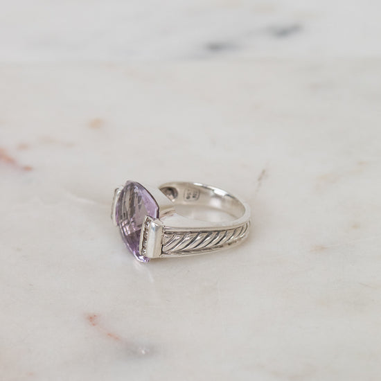 Squared amethyst center stone with diamond side panel and silver cable band details