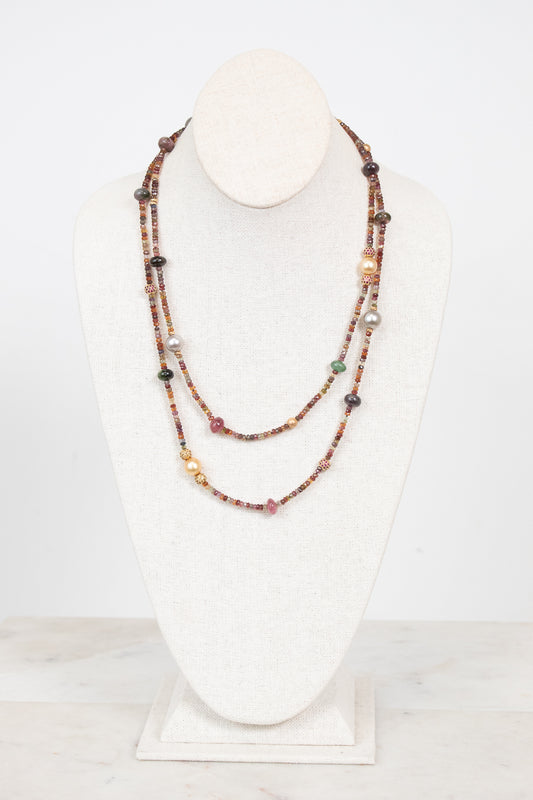 Autumnal tone beaded layered necklace displayed on a bust and against a plain background