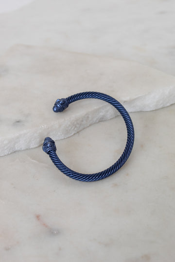 Blue cable bracelet on a marble surface