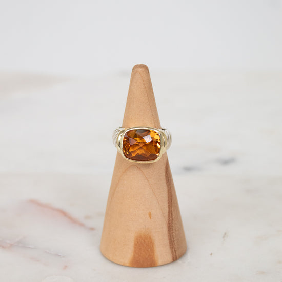 Oval citrine stone face ring on wooden stand