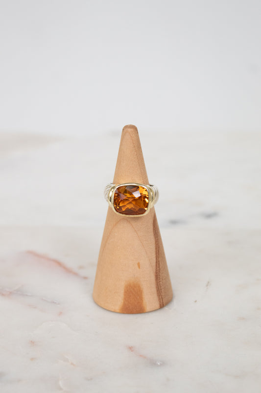 Oval citrine stone face ring on wooden stand