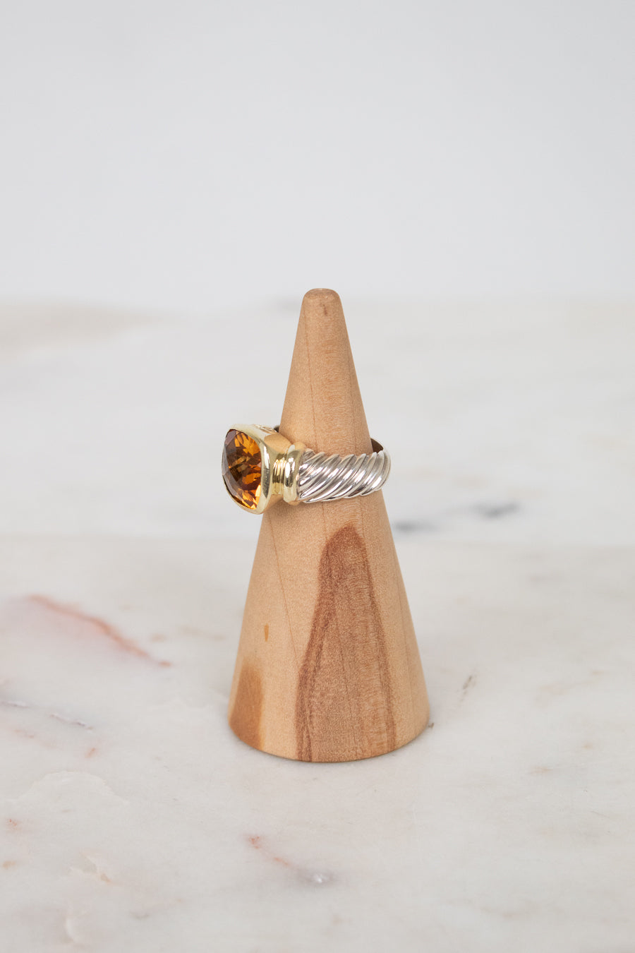 Side view of citrine stone and visible silver and gold hardware