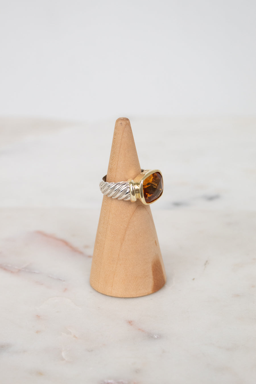 Side view of citrine stone and visible silver and gold hardware
