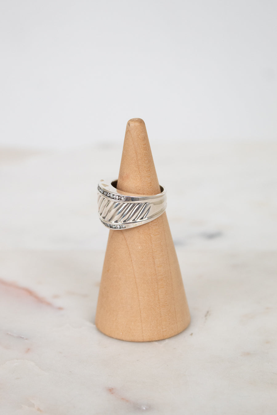 Side view of silver cable band ring with diamond border details