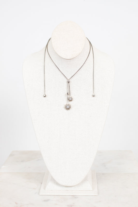 Necklace with a starburst pendant on a white background