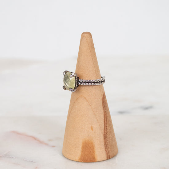 Ring on a wooden cone with a white background