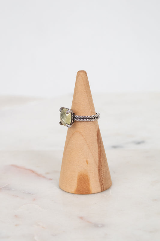 Ring on a wooden cone with a white background