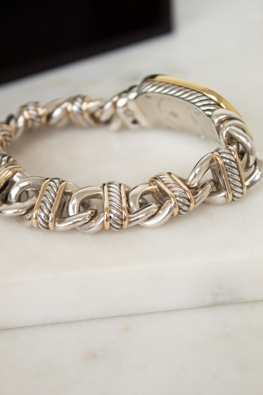 Close-up of gold and silver watch band