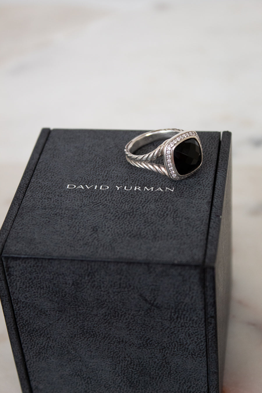 Silver ring on a David Yurman box