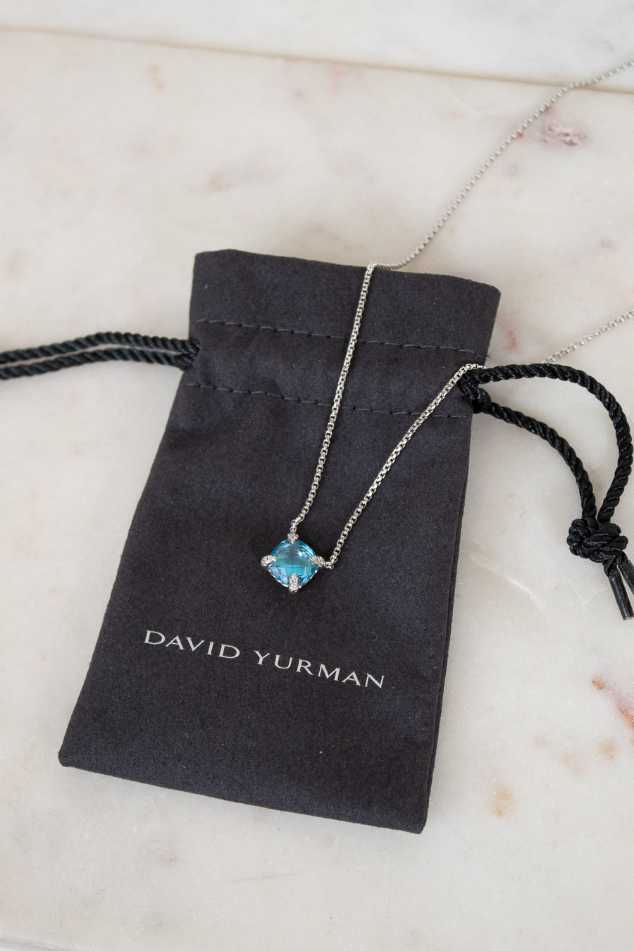 David Yurman necklace with blue gemstone on a branded pouch